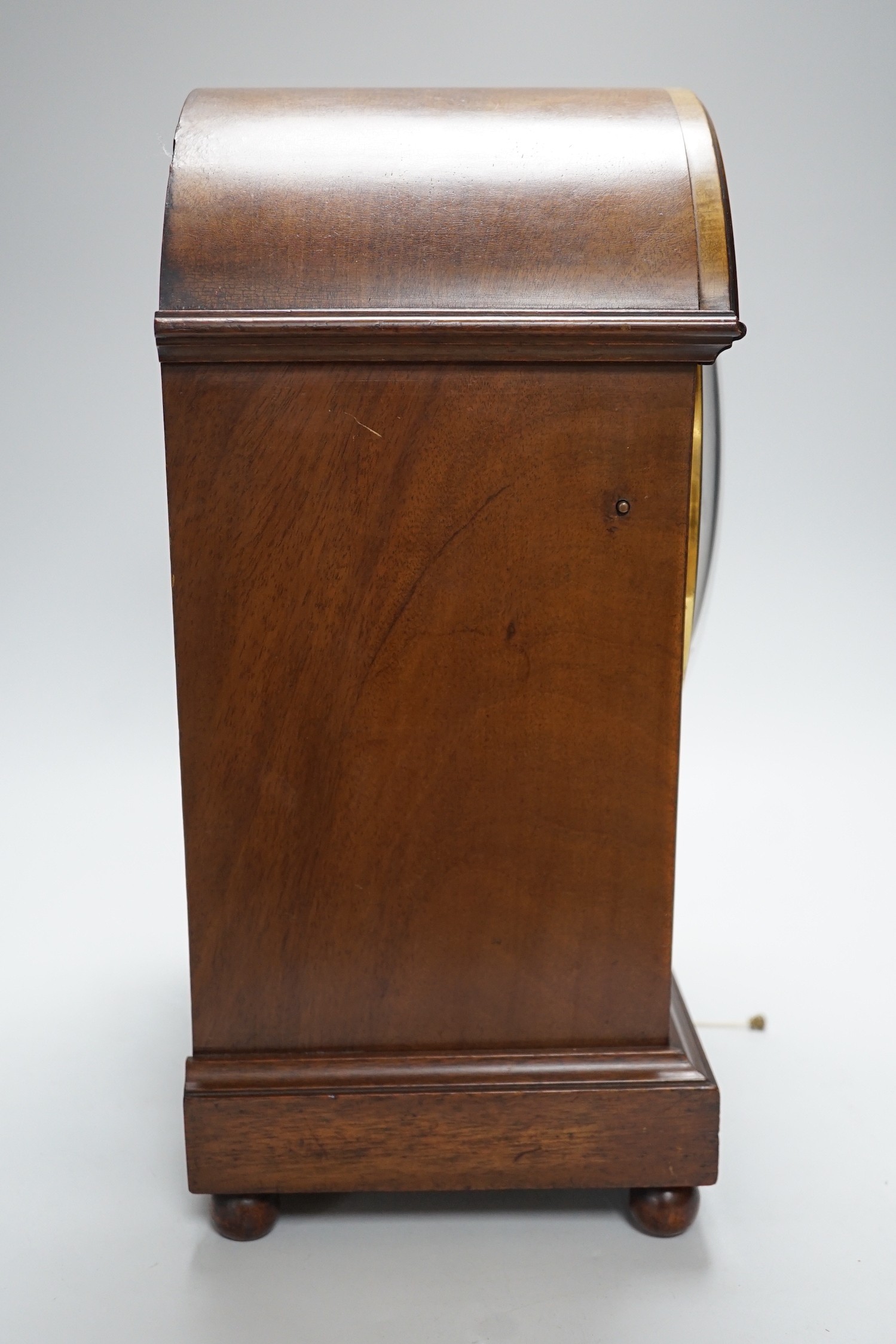 A late 19th/early 20th century mahogany mantel clock with German striking movement and convex silvered dial. 38cm tall